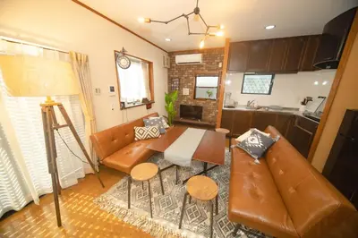 a living room with a couch and a table at Jomira & Jony House in Tokyo