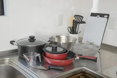 a kitchen counter with pots and pans on a sink at Jomira & Jony House in Tokyo