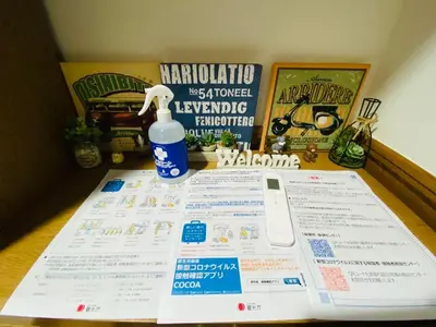 a table with a menu and a bottle of water at Jomira & Jony House in Tokyo