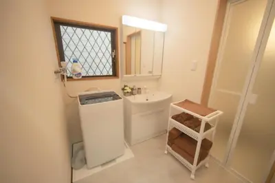 a small bathroom with a sink and a mirror at Jomira & Jony House in Tokyo