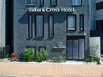 a black building with a sign that reads saka cross hotel at Sakura Cross Hotel Shinjuku East Annex in Tokyo