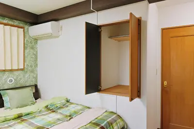 a small bedroom with a bed and a cabinet at Terrace Terano#201 in Tokyo