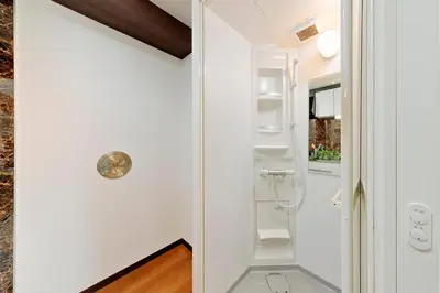 a small bathroom with white walls and white shelves at Terrace Terano#201 in Tokyo