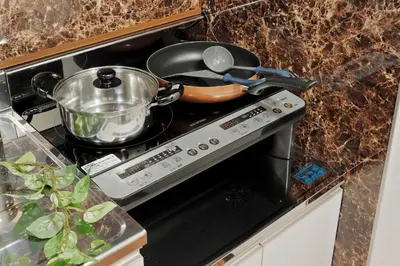 a stove top with a pot and a pan on it at Terrace Terano#201 in Tokyo