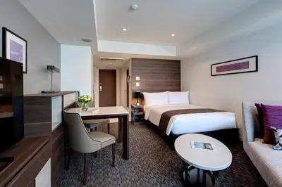 a hotel room with a bed and a couch at Somerset Ginza East Tokyo in Tokyo