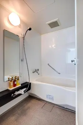 a white bathroom with a tub and a shower at Somerset Ginza East Tokyo in Tokyo