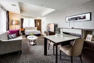 a hotel room with a bed and a living room at Somerset Ginza East Tokyo in Tokyo