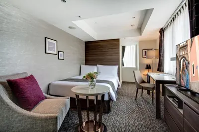 a hotel room with a bed and a tv at Somerset Ginza East Tokyo in Tokyo