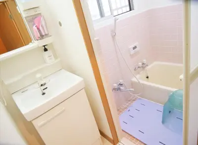a bathroom with a sink and a toilet and a tub at Koto-ku - House / Vacation STAY 76385 in Tokyo