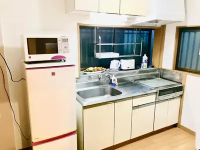 a kitchen with a sink and a microwave at Koto-ku - House / Vacation STAY 76385 in Tokyo