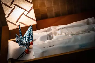 a white envelope with a piece of paper and a thermometer at kaguya asakusa Women only guest house in Tokyo