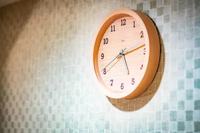 a clock is hanging on a wall at kaguya asakusa Women only guest house in Tokyo