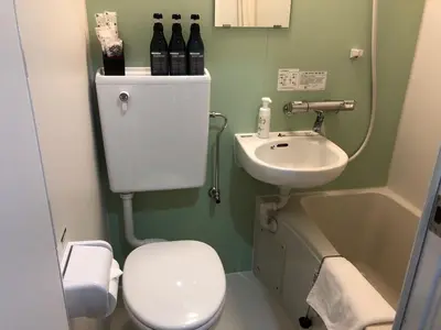 a small bathroom with a toilet and a sink at Wa no Kaede in Tokyo