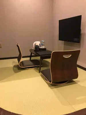 a room with two chairs and a table and a television at Wa no Kaede in Tokyo