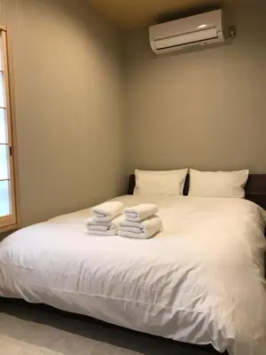 a bedroom with a bed with white towels on it at Wa no Kaede in Tokyo