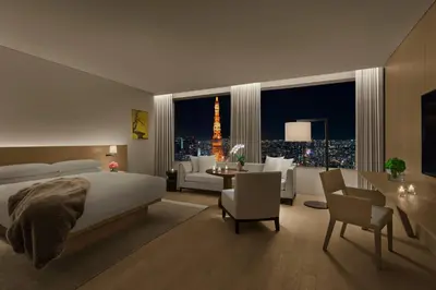 a bedroom with a bed and a view of a city at The Tokyo EDITION, Toranomon in Tokyo