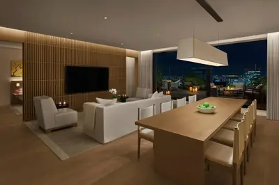 a dining room and living room with a table and chairs at The Tokyo EDITION, Toranomon in Tokyo