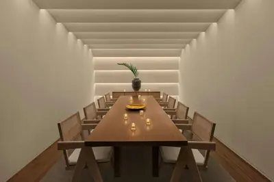 a dining room with a wooden table and chairs at The Tokyo EDITION, Toranomon in Tokyo