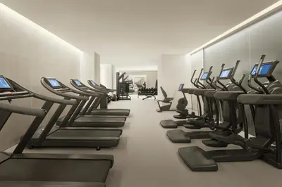a gym with a row of treadmills at The Tokyo EDITION, Toranomon in Tokyo