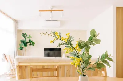 a living room with a table with yellow flowers at Akiba Residence in Tokyo