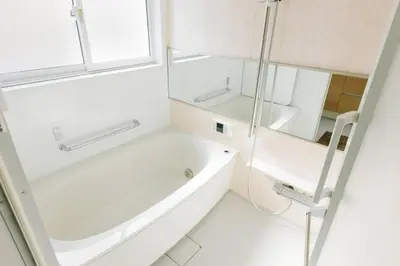 a white bathroom with a tub and a mirror at Akiba Residence in Tokyo
