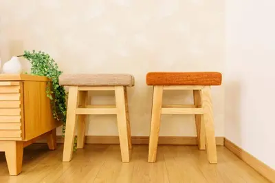 two wooden stools sitting next to a wall at Akiba Residence in Tokyo