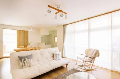 a living room with a white couch and a chair at Akiba Residence in Tokyo
