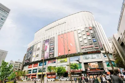 a large building with people walking in front of it at Akiba Residence in Tokyo