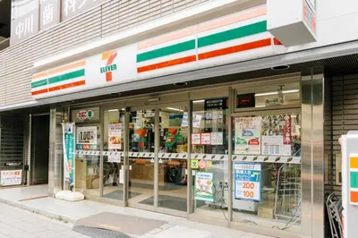 a store front of a store with signs in the windows at Akiba Residence in Tokyo