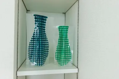 two green vases are sitting on a shelf at Re-Rent Residence \u62bc\u4e0a in Tokyo