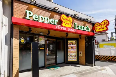 a fast food restaurant with signs on the front of it at Re-Rent Residence \u62bc\u4e0a in Tokyo