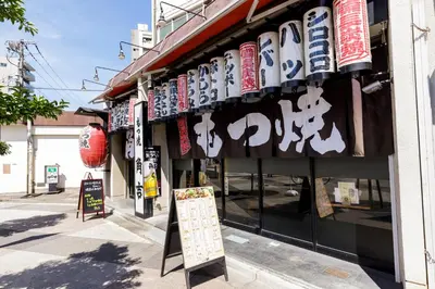 a restaurant with signs on the side of a building at Re-Rent Residence \u62bc\u4e0a in Tokyo