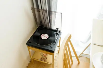 a record player on a table next to a window at Re-Rent Residence \u62bc\u4e0a in Tokyo