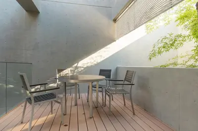 a table and chairs sitting on a deck at Azabu Modern House The Tokyo Tower can be seen from the villa 500m2 in Tokyo