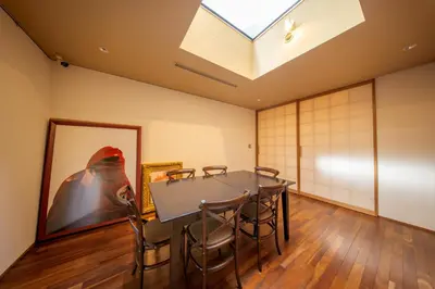 a dining room with a table and chairs and a skylight at Azabu Modern House The Tokyo Tower can be seen from the villa 500m2 in Tokyo