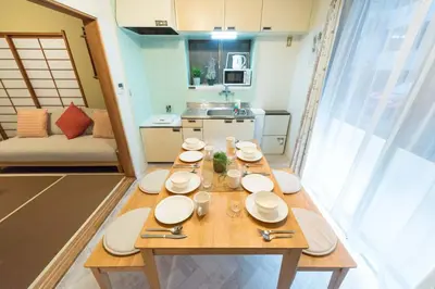 a dining room table with white plates on it at Shinjuku-ku - House / Vacation STAY 6644 in Tokyo