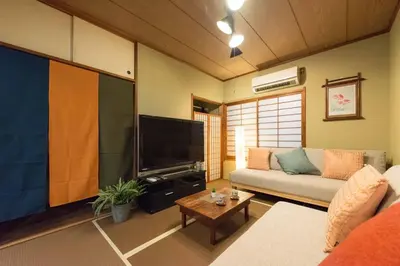 a living room with a couch and a flat screen tv at Shinjuku-ku - House / Vacation STAY 6644 in Tokyo