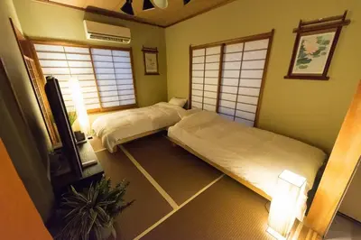 a bedroom with two beds and a tv in it at Shinjuku-ku - House / Vacation STAY 6644 in Tokyo