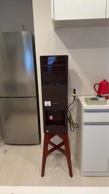 a computer on a stand in a kitchen with a refrigerator at Tachibana in Tokyo