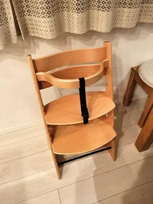 a wooden chair with a black ribbon around it at Tachibana in Tokyo