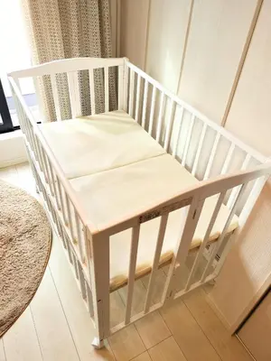 a white crib with a table in a room at Tachibana in Tokyo