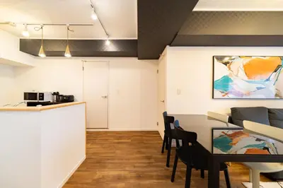 a kitchen and a living room with a table and chairs at Eims stay Oomori304 in Tokyo