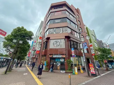 a tall building with a clock on it on a street at Eims stay Oomori304 in Tokyo