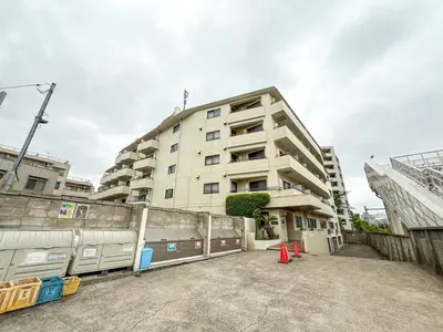 an apartment building with a parking lot in front of it at Eims stay Oomori304 in Tokyo