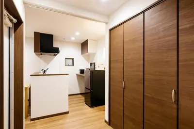 a kitchen with wooden cabinets and a kitchen island at Crescent Moon Nakanoshimbashi in Tokyo