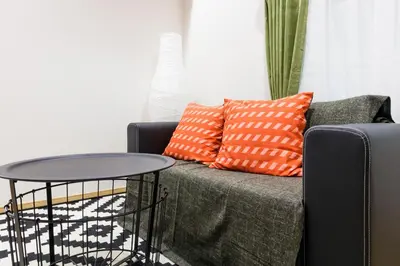 a living room with a couch and a table at Crescent Moon Nakanoshimbashi in Tokyo