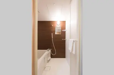 a bathroom with a bath tub and a shower stall at TORA HOTEL Tokyo Skytree \u5bc5\u30db\u30c6\u30eb \u30b9\u30ab\u30a4\u30c4\u30ea\u30fcC in Tokyo