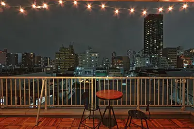 a balcony with a table and chairs and a city skyline at V.Close to Nishi-Shinjuku/FrWIF/ Roof top Terrace in Tokyo