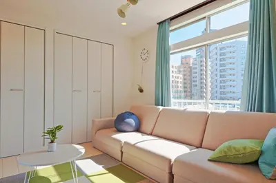 a living room with a couch and a large window at V.Close to Nishi-Shinjuku/FrWIF/ Roof top Terrace in Tokyo