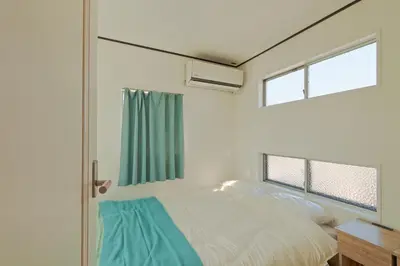 a bedroom with a bed and two windows at V.Close to Nishi-Shinjuku/FrWIF/ Roof top Terrace in Tokyo